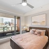 bedroom with nightstands and a large bed and window
