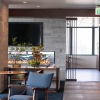 community area with a tv, large windows and ample seating options