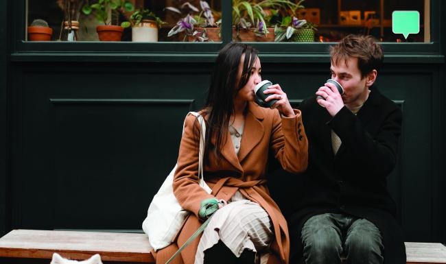 a person sitting on a bench with a dog